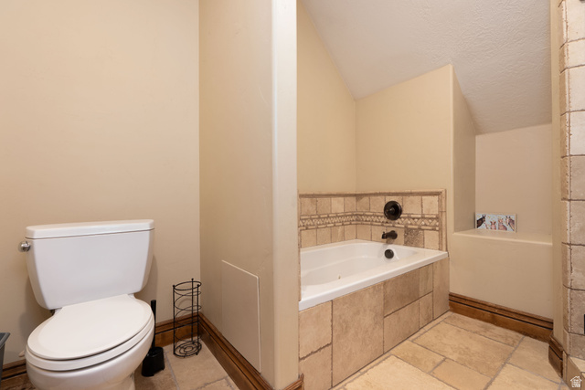 687 South 2080th Street East Springville, UT 84663 - Photo 59 of 149 Bathroom featuring an inset soaking tub with tiled surround, a tiled floor, and a neutral wall color
