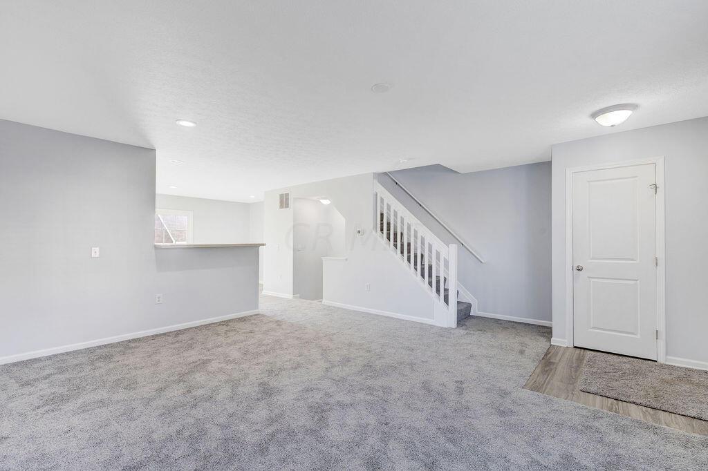 6345 Needletail Road, Unit 24634 Columbus, OH 43230 - Photo 4 of 58 • New gray carpet ~ 2021 • Gray painted walls • Ceiling light • Can lighting in Dining Area • 2” blinds