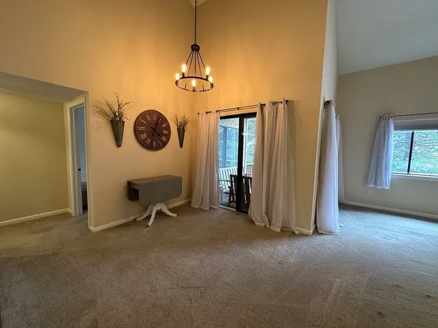a view of a livingroom with a kitchen and a window