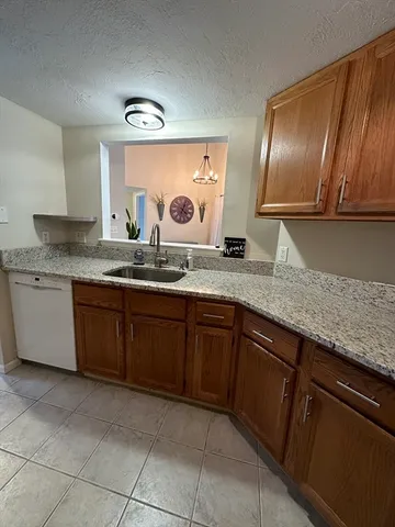 a kitchen with granite countertop stainless steel appliances and cabinets