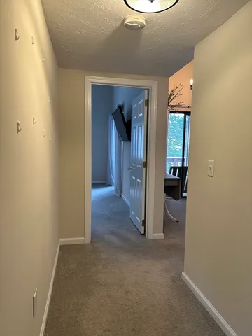 a view of a hallway with wooden shelves