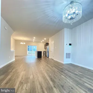 a large kitchen with stainless steel appliances kitchen island granite countertop a refrigerator a sink and dishwasher