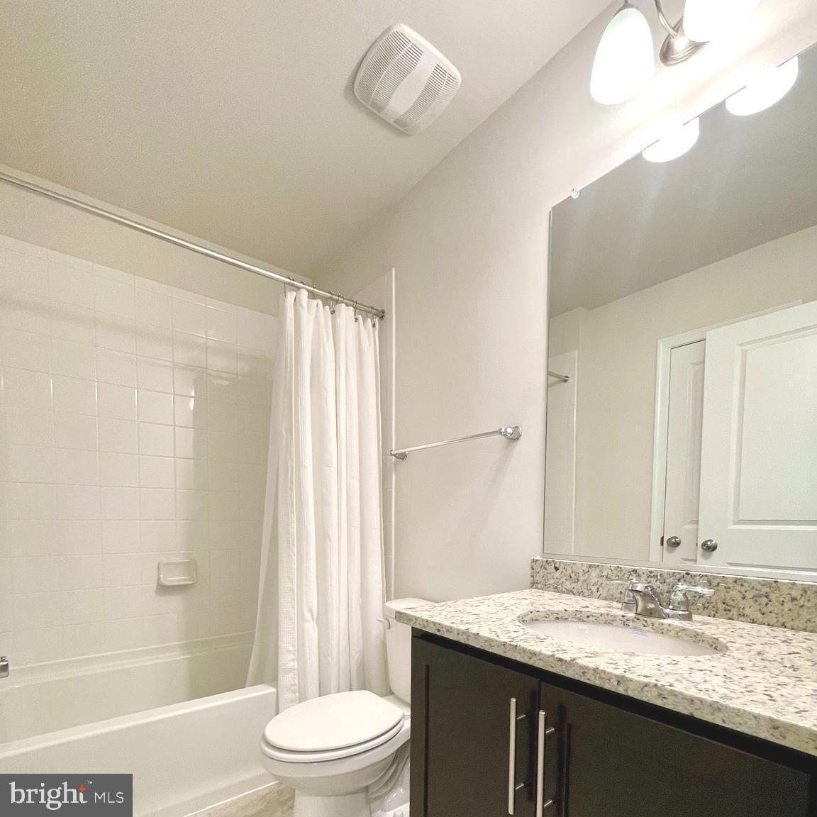 2709 Princess Victoria Way Bowie, MD 20721 - Photo 23 of 31 a bathroom with a granite countertop sink toilet a mirror and shower