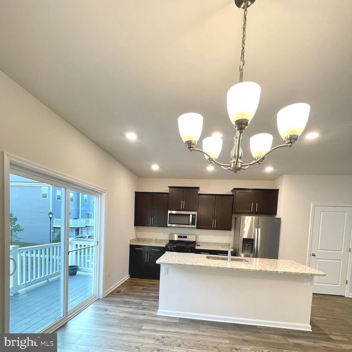 2709 Princess Victoria Way Bowie, MD 20721 - Photo 5 of 31 a view of kitchen with microwave stove dining table and chairs