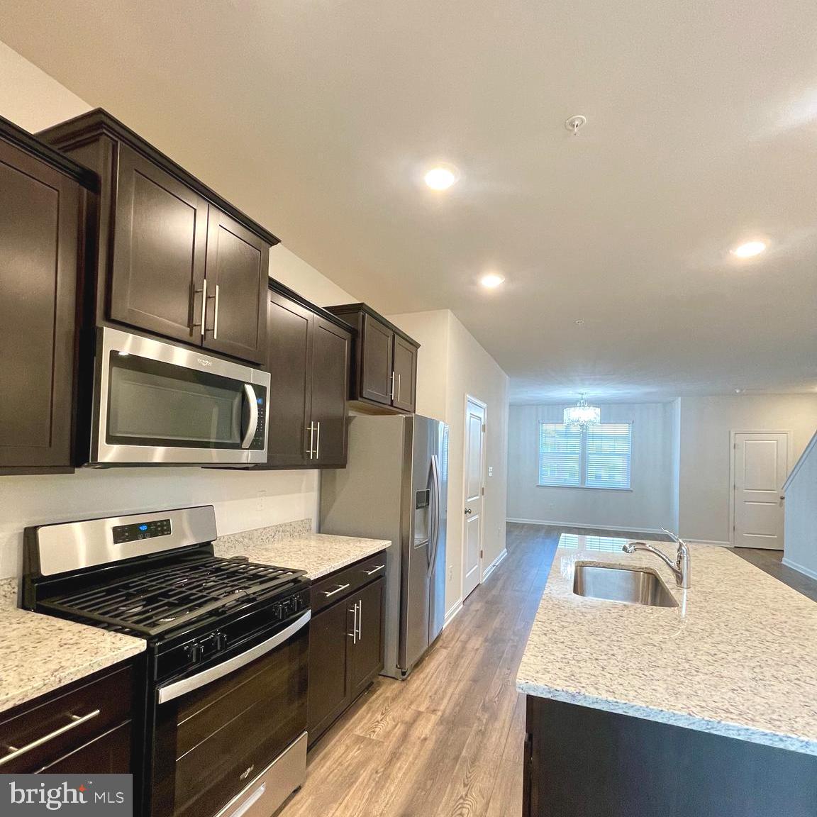 2709 Princess Victoria Way Bowie, MD 20721 - Photo 7 of 31 a kitchen with granite countertop stainless steel appliances and wooden cabinets