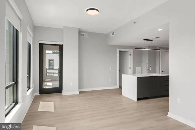 an empty room with windows and closet