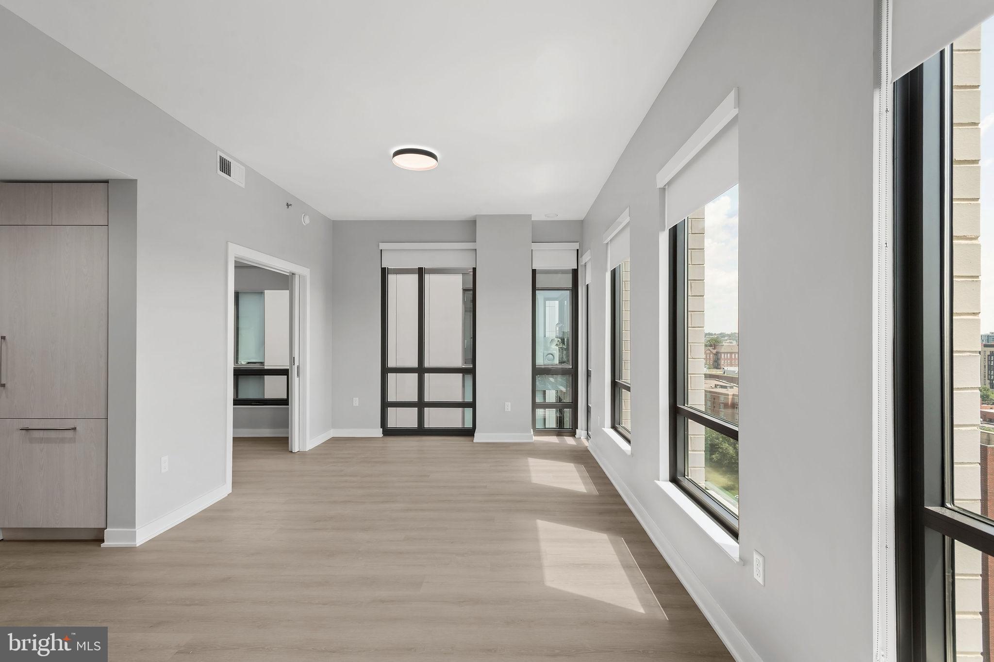 950 3rd Street Northwest, Unit PH1202 Washington, DC 20001 - Photo 31 of 45 an empty room with windows and closet