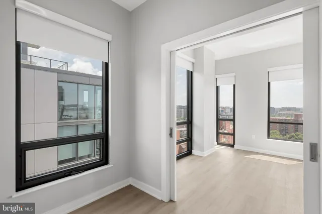 an empty room with windows and closet