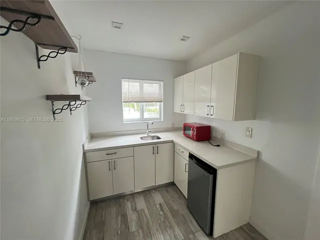 a utility room with cabinets washer and dryer