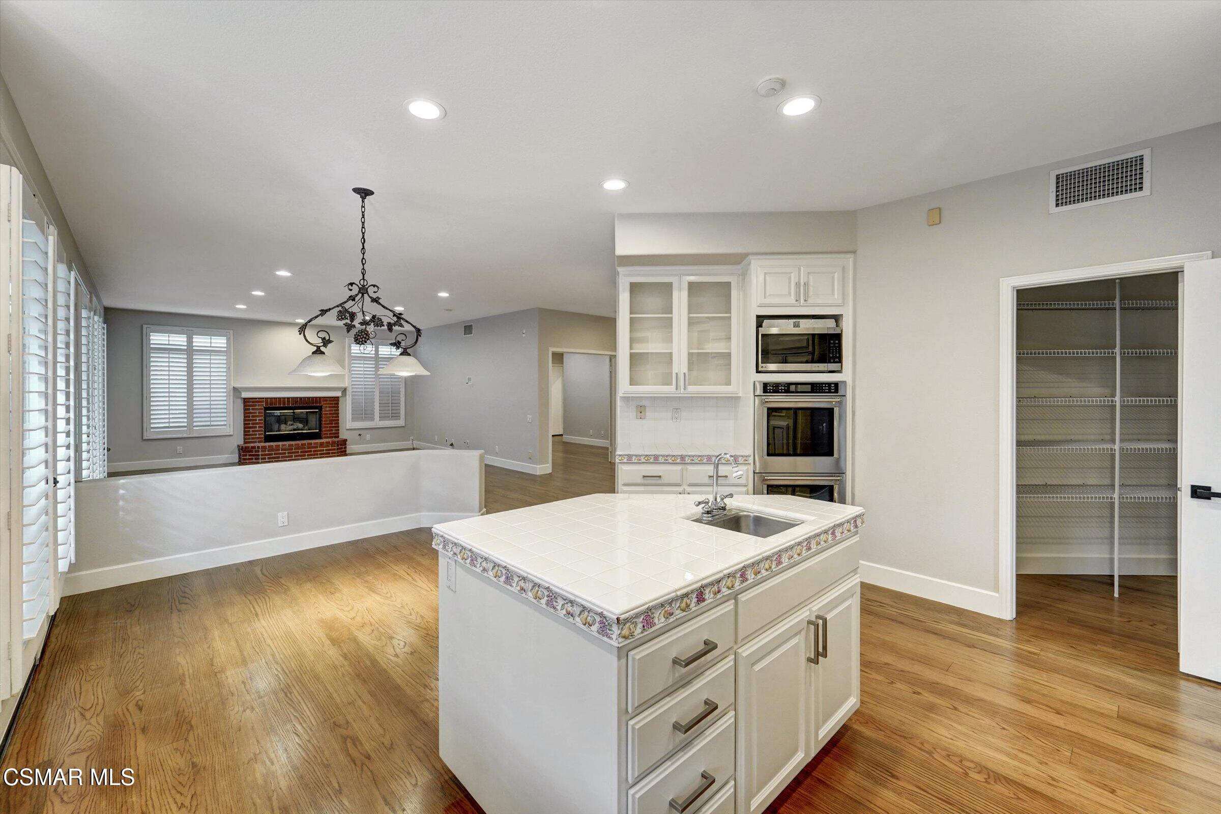 4101 Laurelview Drive Moorpark, CA 93021 - Photo 14 of 49 a kitchen with a stove and a wooden floor
