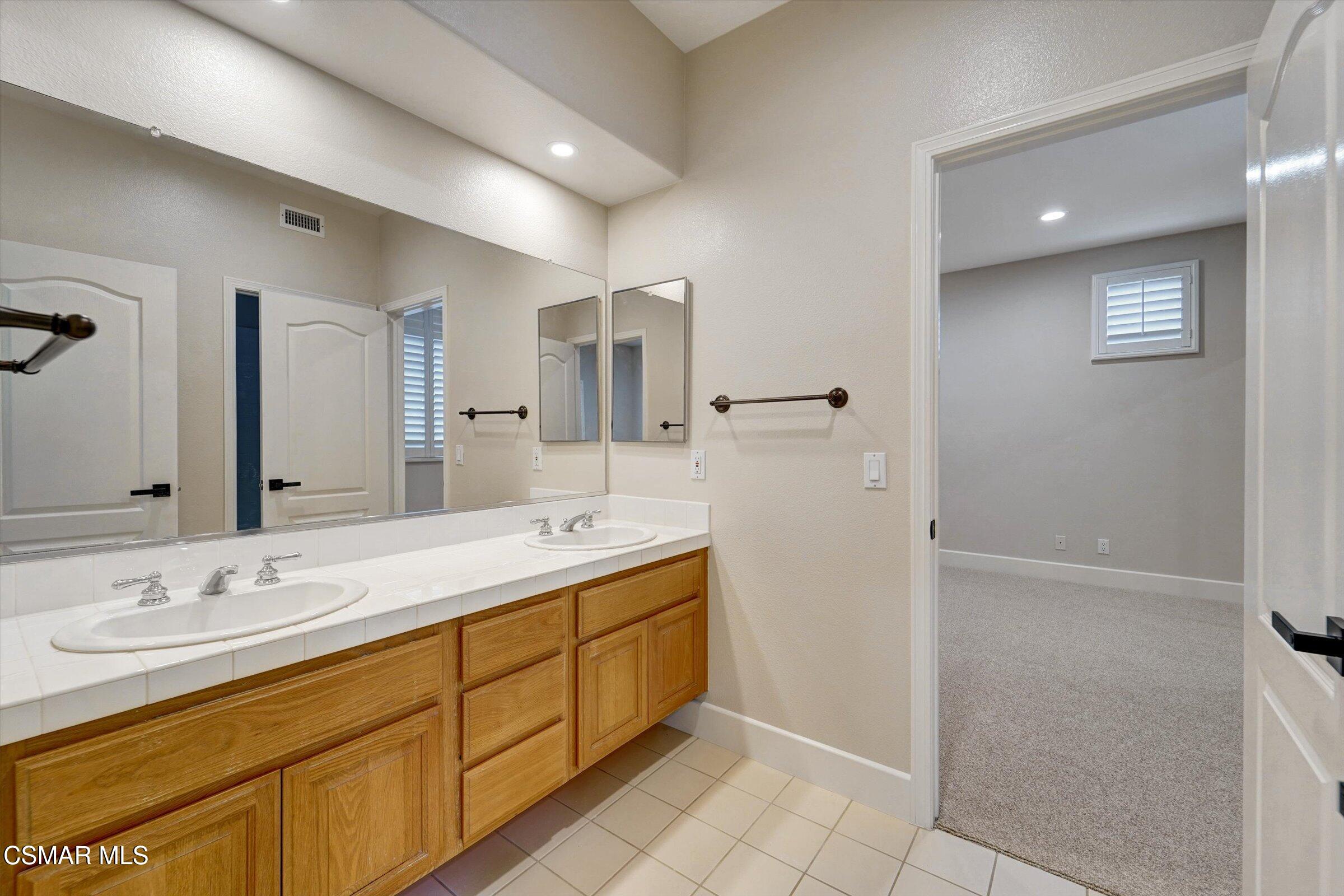 4101 Laurelview Drive Moorpark, CA 93021 - Photo 30 of 49 a spacious bathroom with a double vanity sink mirror and