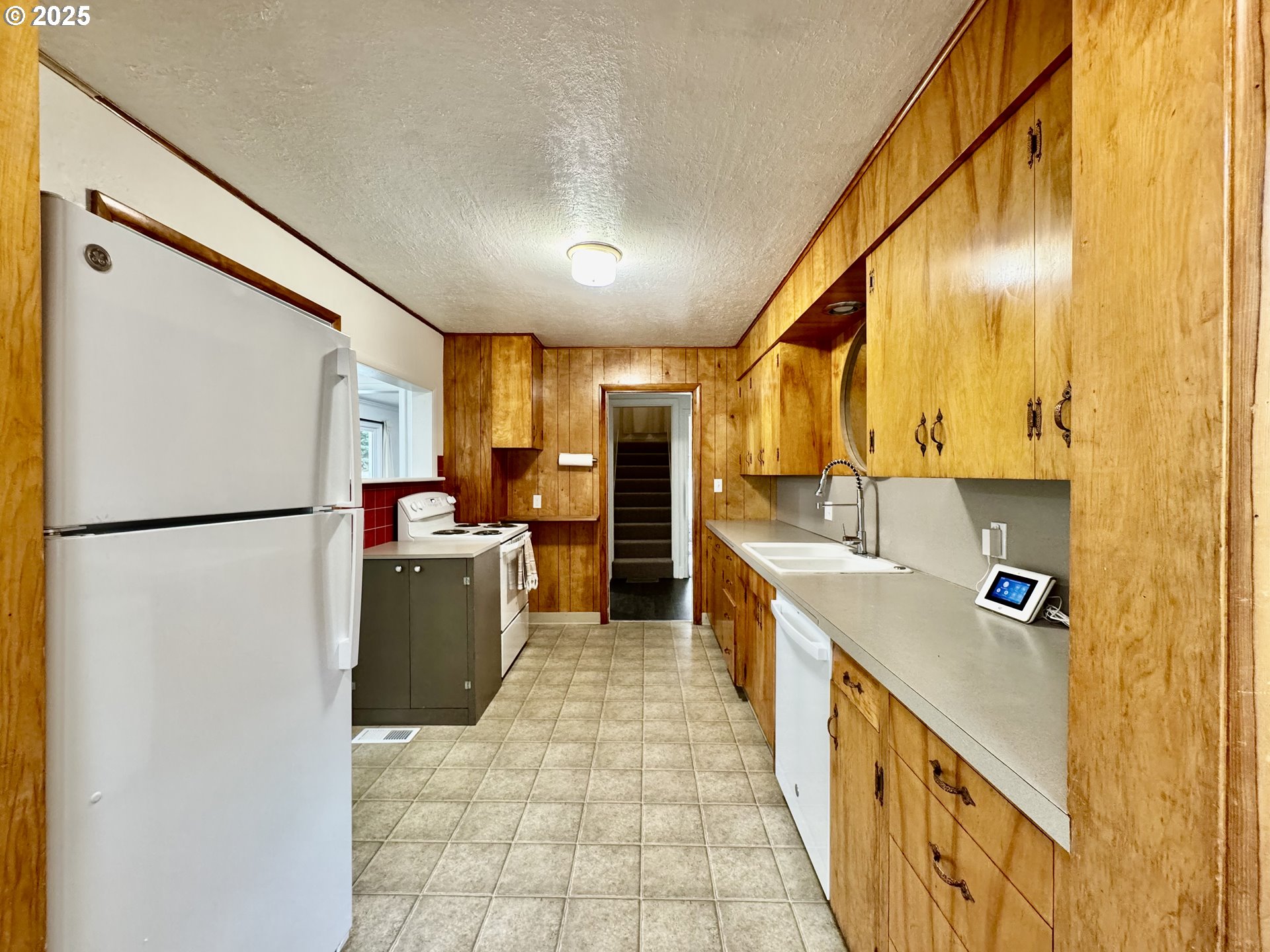 34603 Church Road Warren, OR 97053 - Photo 18 of 42 a kitchen with sink cabinets and stainless steel appliances