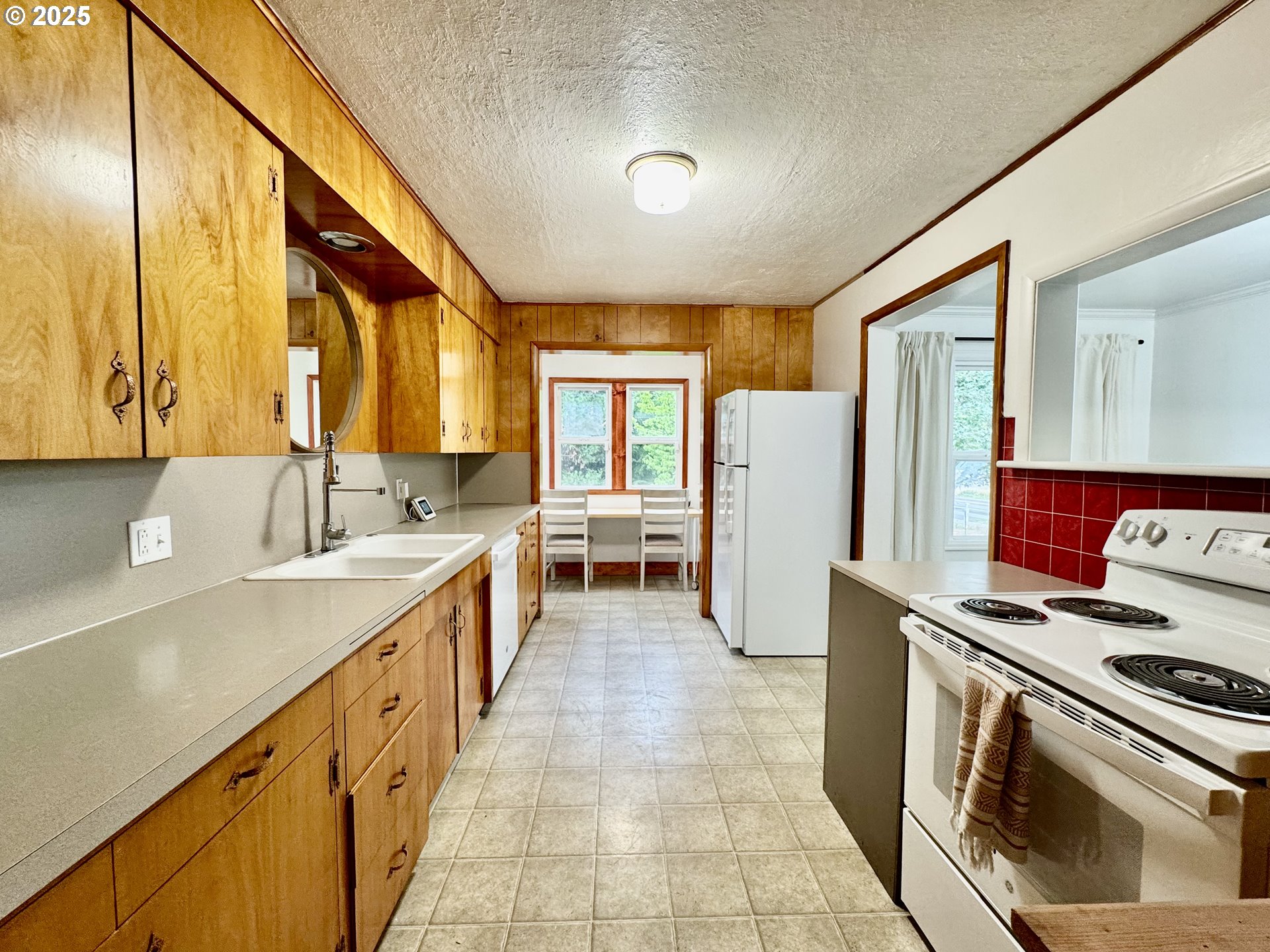 34603 Church Road Warren, OR 97053 - Photo 20 of 42 a kitchen with a sink stove and refrigerator
