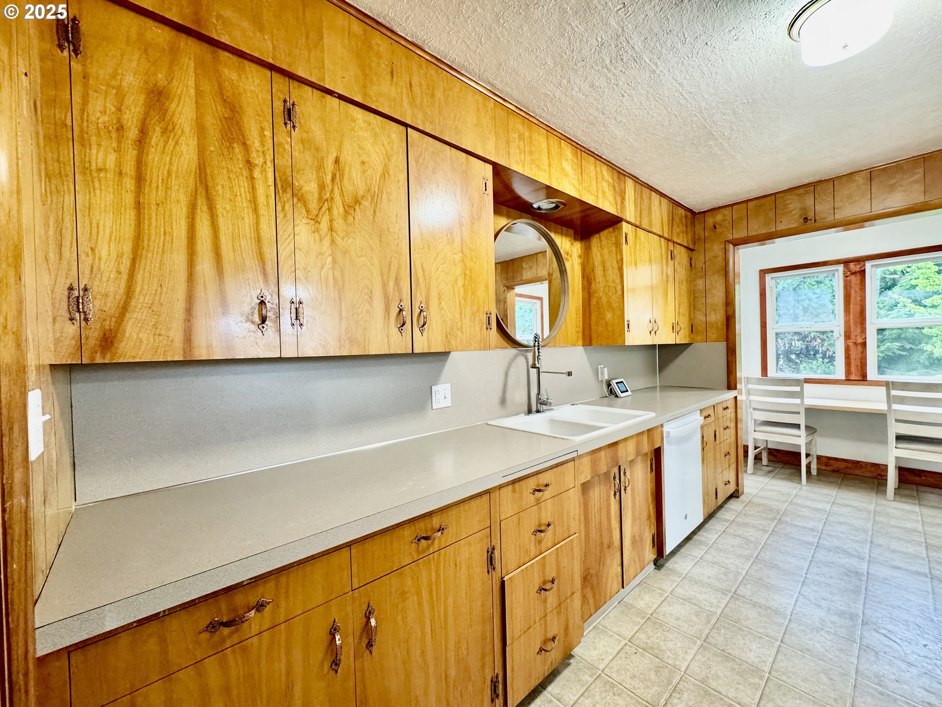 34603 Church Road Warren, OR 97053 - Photo 22 of 42 a large white kitchen with a large window