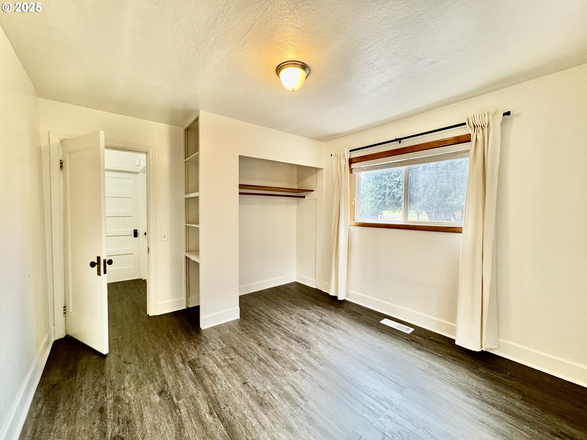 34603 Church Road Warren, OR 97053 - Photo 24 of 42 an empty room with wooden floor and windows