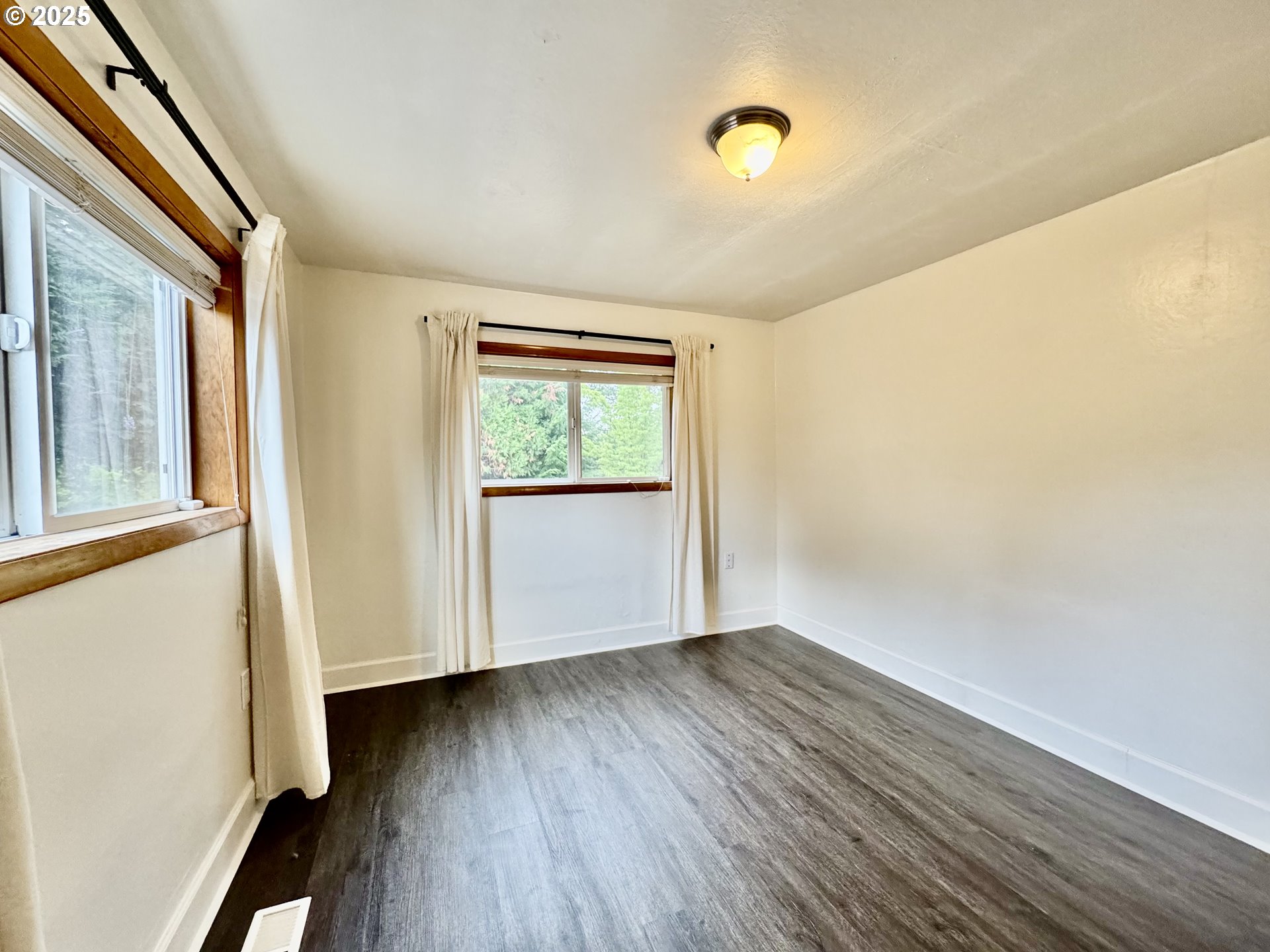 34603 Church Road Warren, OR 97053 - Photo 25 of 42 an empty room with wooden floor and windows