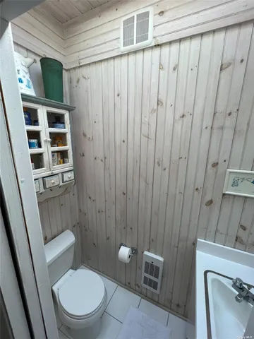 a bathroom with a toilet a sink and shower