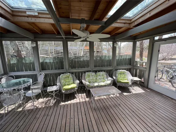 a view of a deck with wooden floor and outdoor seating