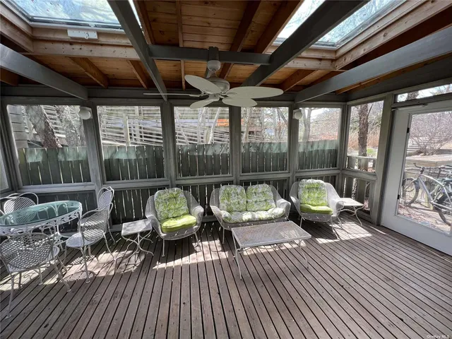 a view of a deck with wooden floor and outdoor seating