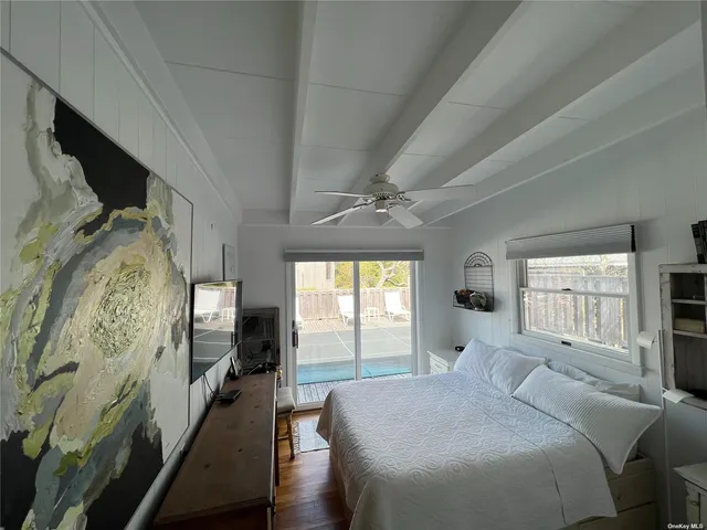 a bedroom with a large bed and a window