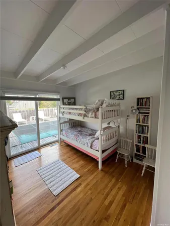 a bedroom with furniture and a wooden floor