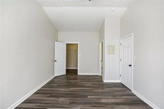 a bathroom with a wooden floor and mirror