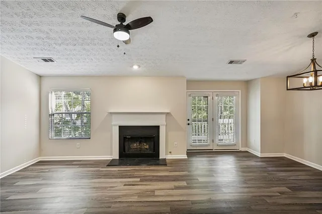 a view of an empty room with a window and fireplace