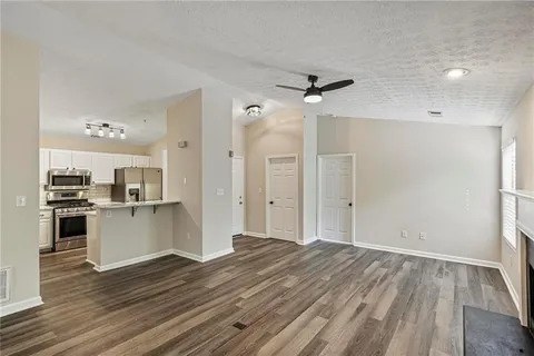 a kitchen with stainless steel appliances a sink a stove a refrigerator and cabinets