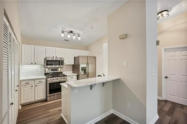 a kitchen with a sink stove and refrigerator