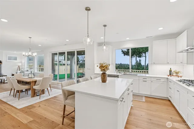 a large kitchen with kitchen island a large center island attached withe living room