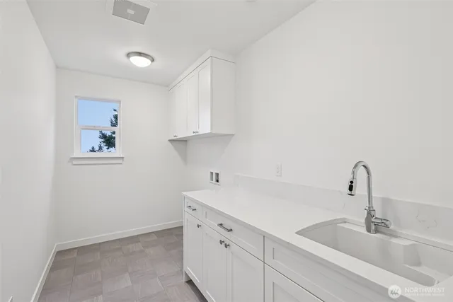 a kitchen with a sink and cabinets