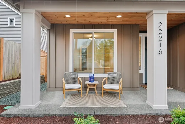 a living room with furniture and large windows