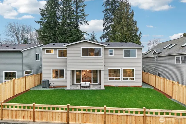 a view of a house with a backyard