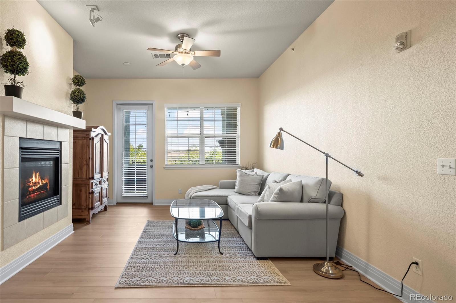 209 Quebec Street, Unit L Denver, CO 80220 - Photo 11 of 46 a living room with furniture and a fireplace