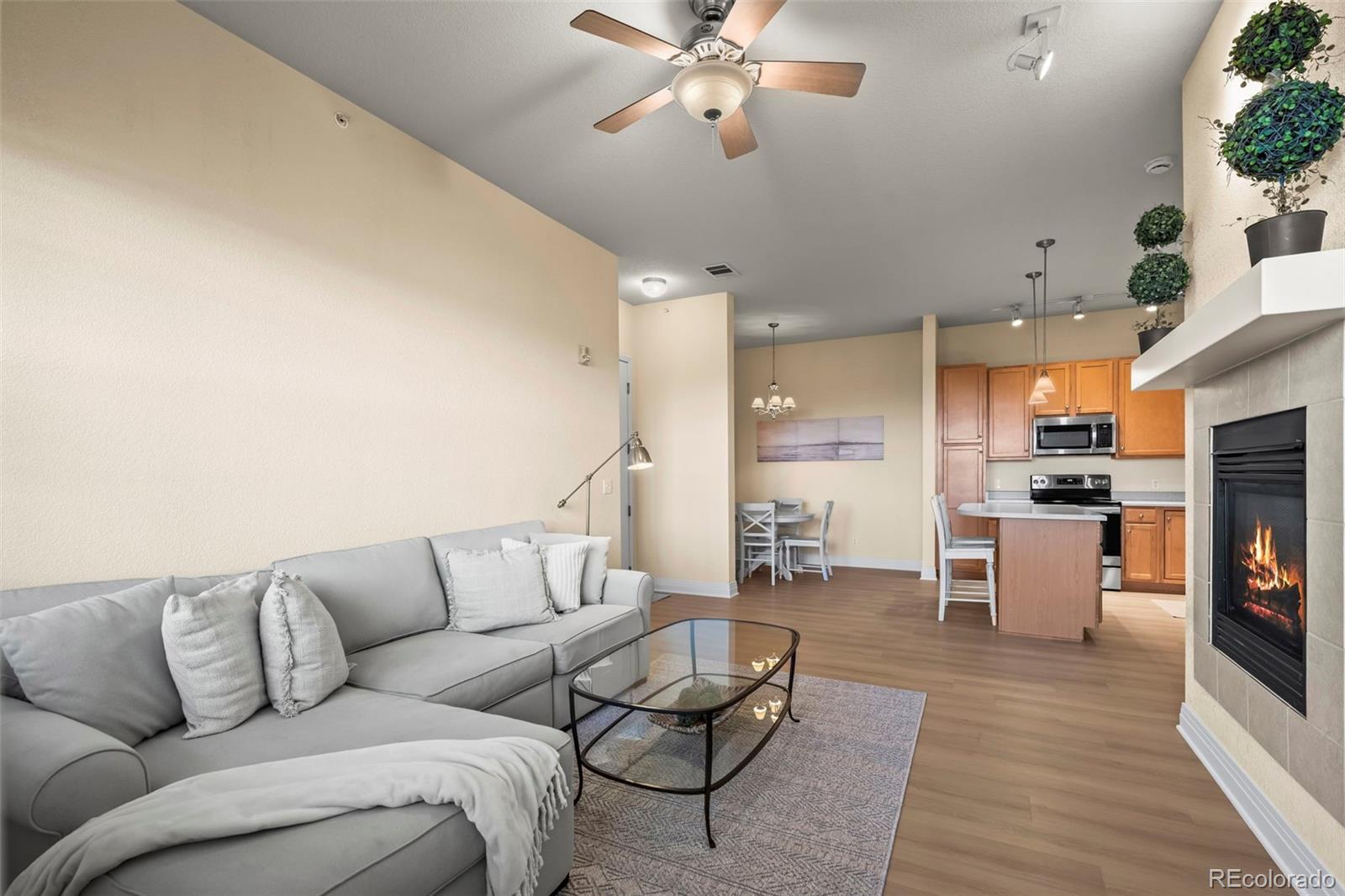 209 Quebec Street, Unit L Denver, CO 80220 - Photo 12 of 46 a living room with furniture and kitchen view