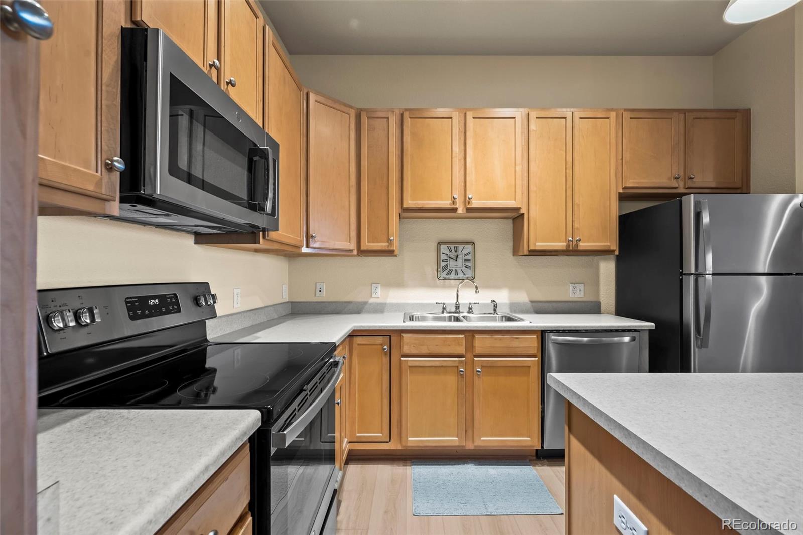 209 Quebec Street, Unit L Denver, CO 80220 - Photo 17 of 46 a kitchen with a sink stove and refrigerator