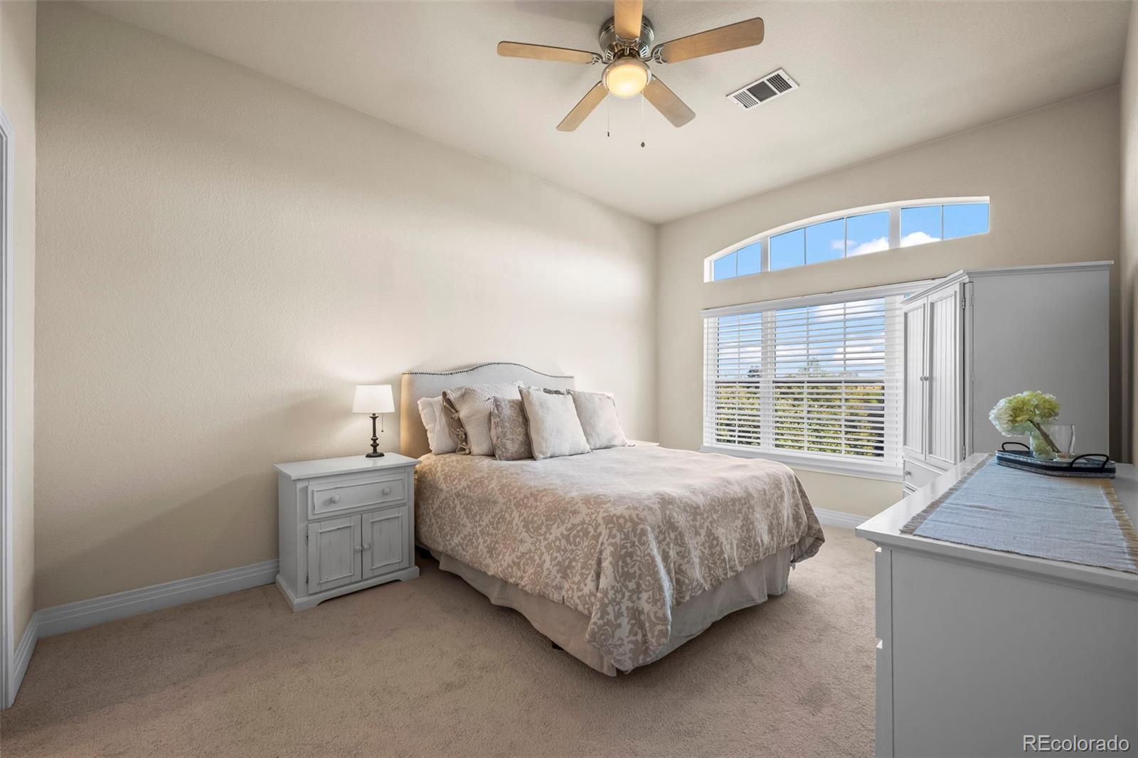 209 Quebec Street, Unit L Denver, CO 80220 - Photo 20 of 46 a bedroom with a bed and a chandelier