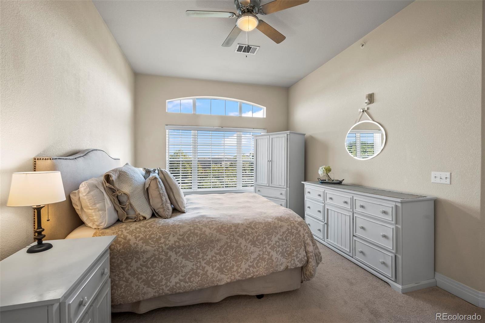 209 Quebec Street, Unit L Denver, CO 80220 - Photo 21 of 46 a bedroom with a large bed and a chandelier