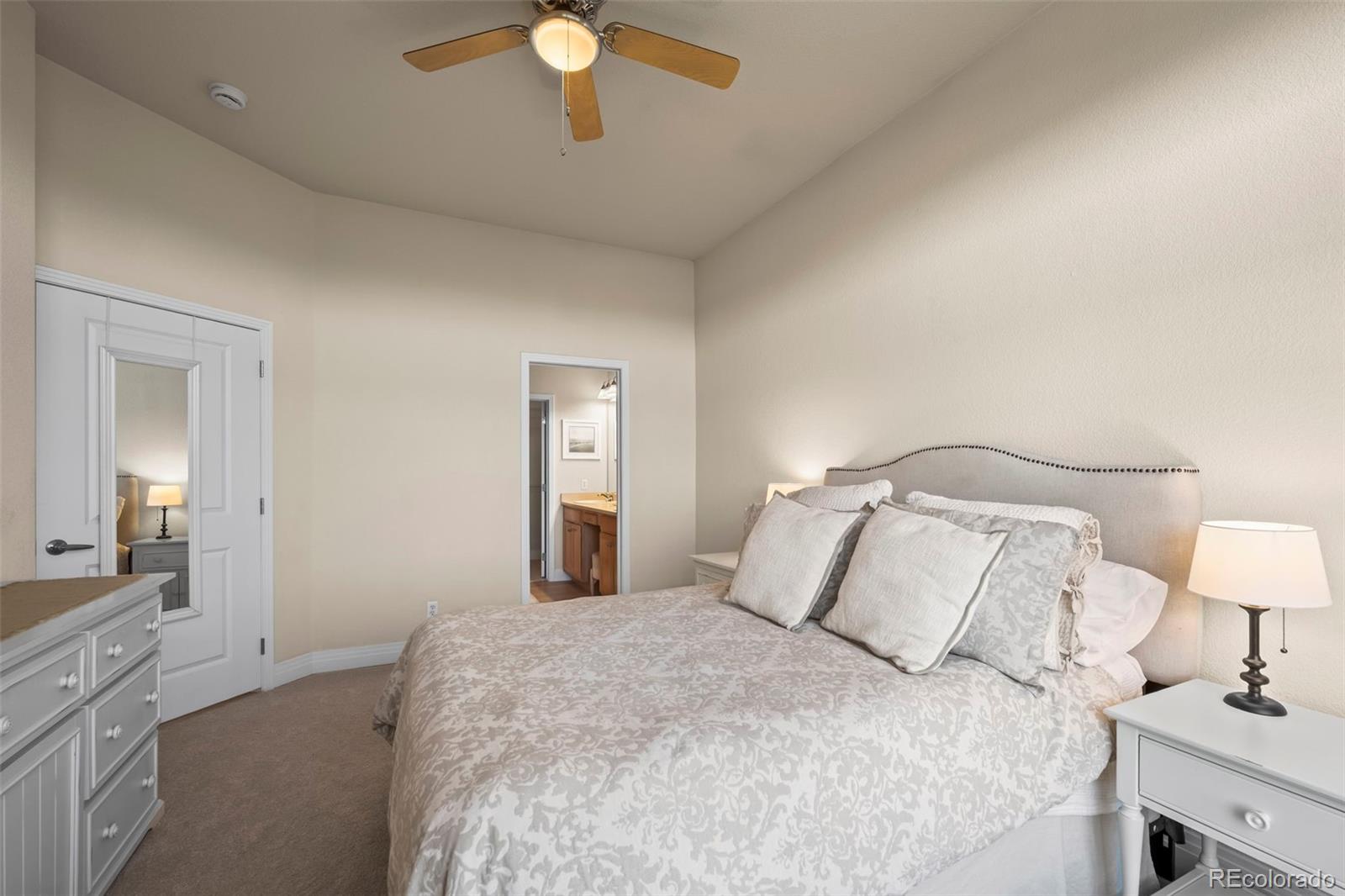 209 Quebec Street, Unit L Denver, CO 80220 - Photo 22 of 46 a bedroom with a bed and a chandelier