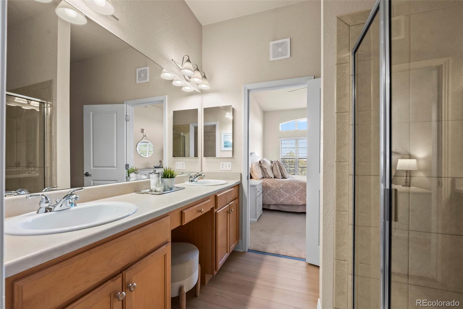 209 Quebec Street, Unit L Denver, CO 80220 - Photo 23 of 46 a spacious en suite bathroom with a granite countertop sink mirror and bathtub