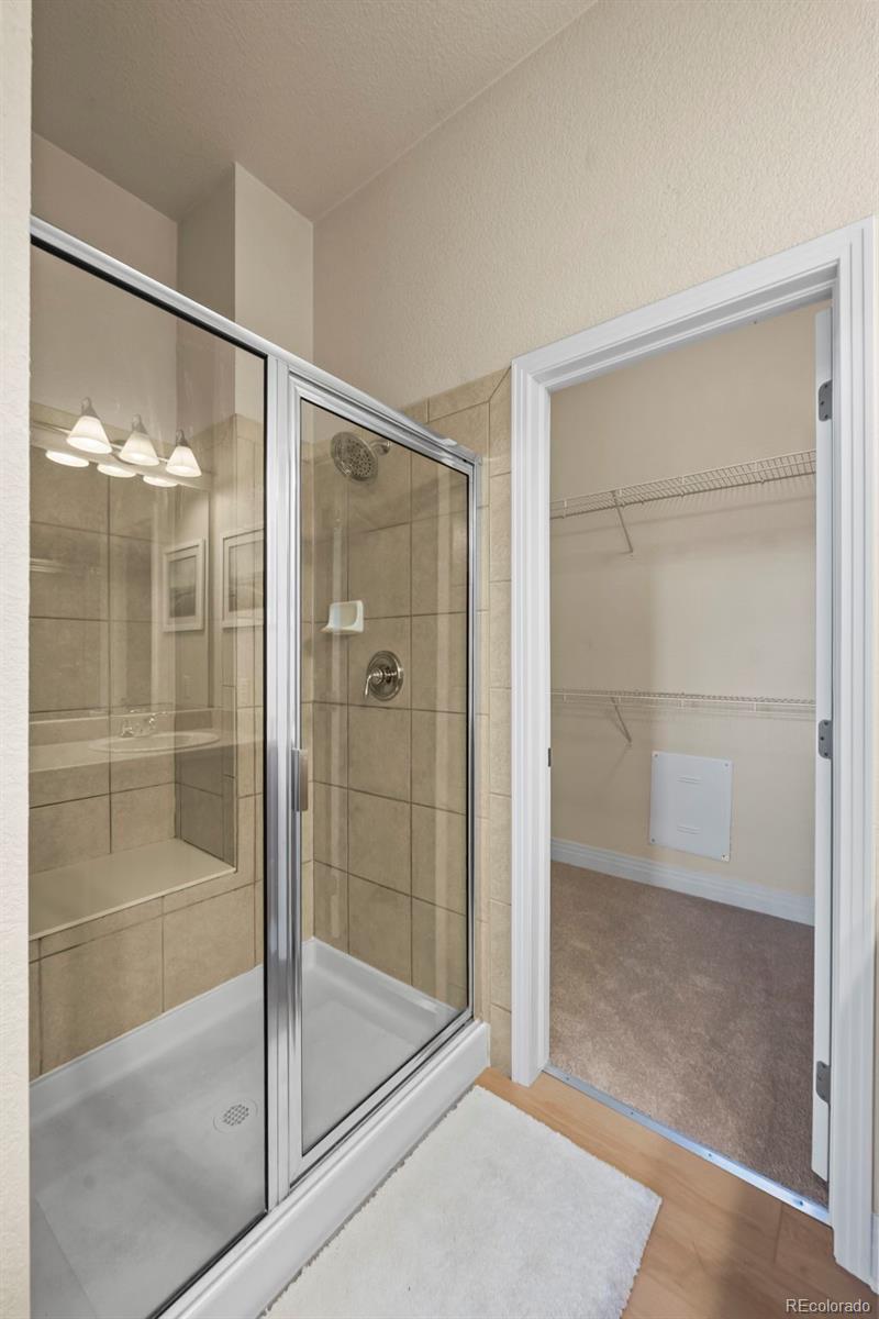 209 Quebec Street, Unit L Denver, CO 80220 - Photo 25 of 46 a bathroom with a glass shower door