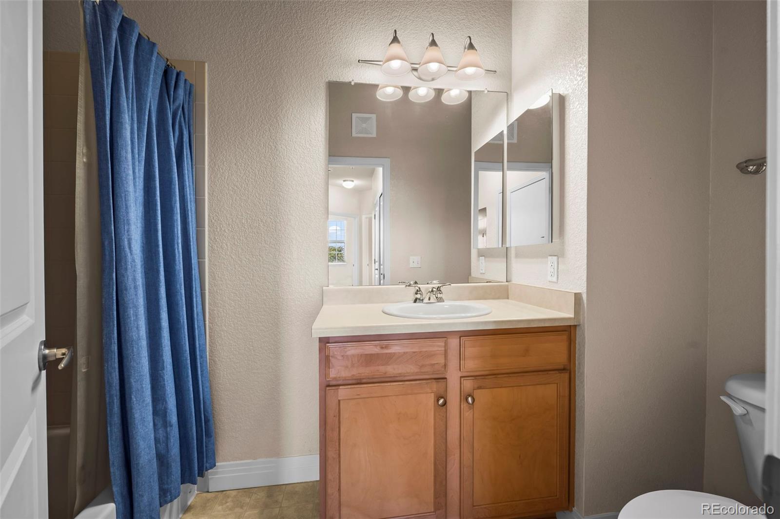 209 Quebec Street, Unit L Denver, CO 80220 - Photo 31 of 46 a bathroom with a sink and a mirror