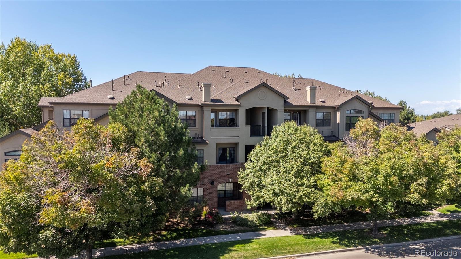 209 Quebec Street, Unit L Denver, CO 80220 - Photo 5 of 46 a front view of a house with a garden and plants