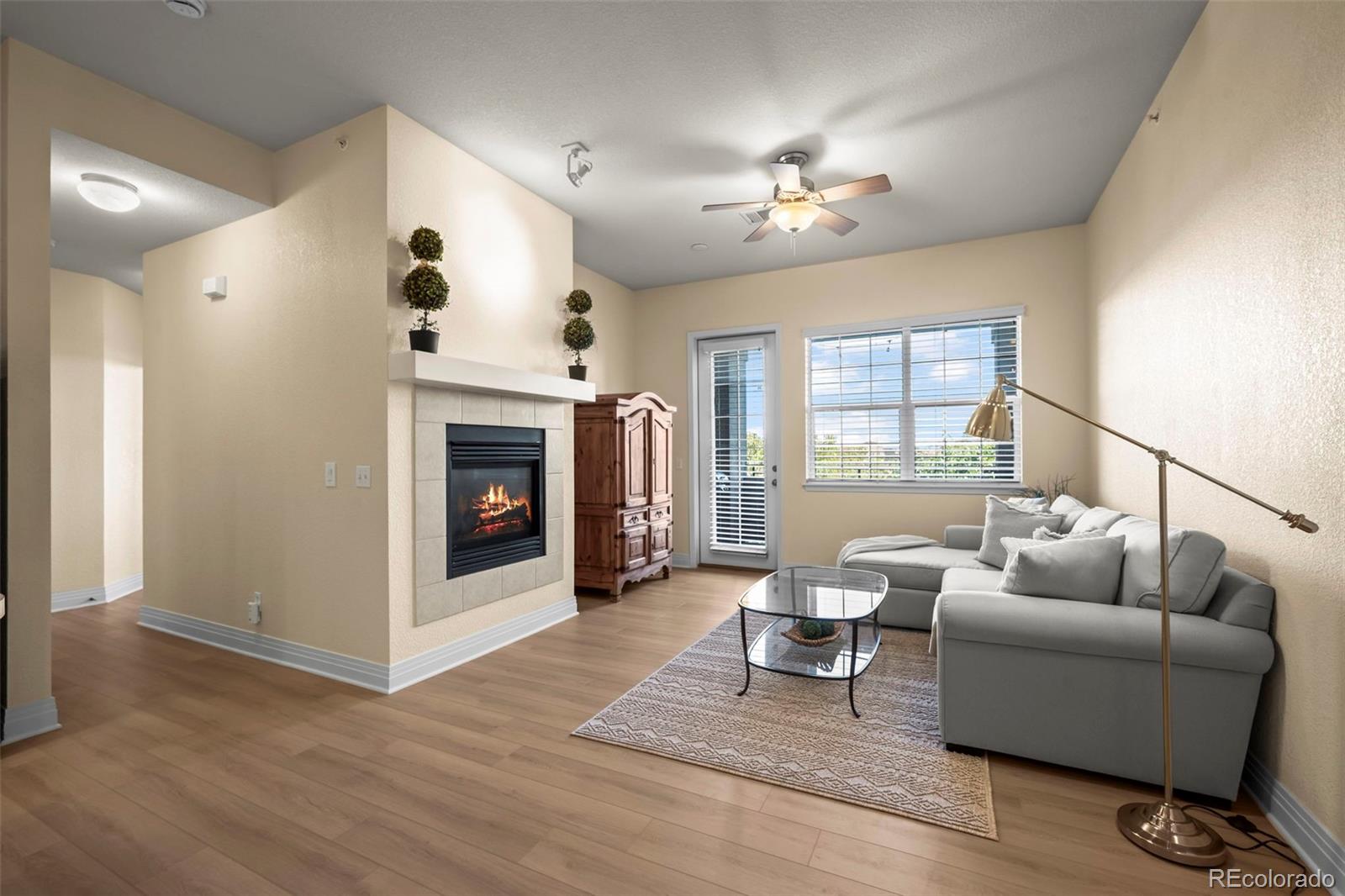 209 Quebec Street, Unit L Denver, CO 80220 - Photo 8 of 46 a living room with furniture and a fireplace