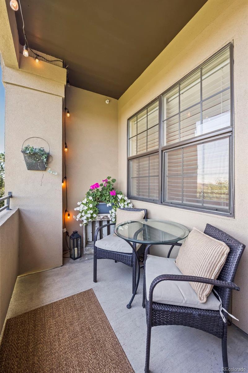 209 Quebec Street, Unit L Denver, CO 80220 - Photo 10 of 46 a living room with furniture and flowers