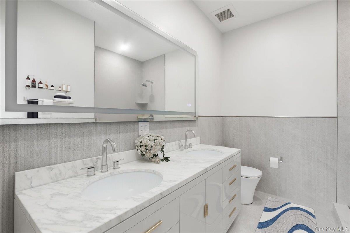 132 Halstead Avenue, Unit D Harrison, NY 10528 - Photo 9 of 19 a bathroom with a sink and a toilet