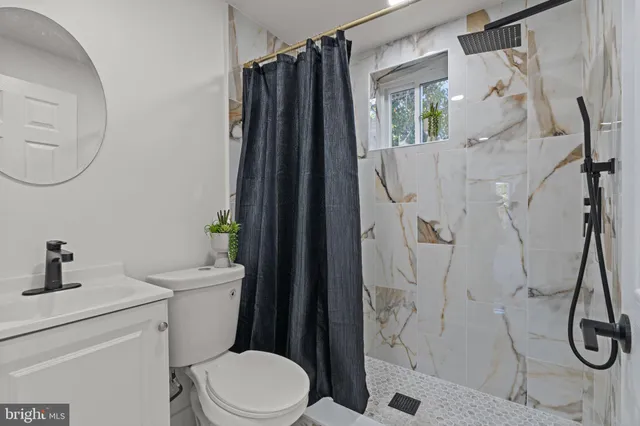 a bathroom with a toilet sink and shower