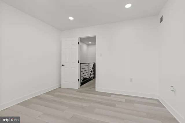 a view of wooden floor and entryway in a room