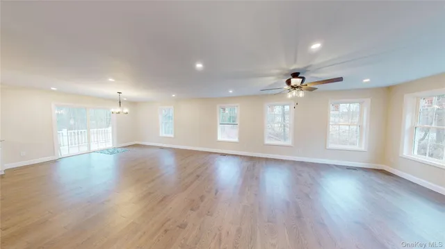a view of kitchen with kitchen island white cabinets and stainless steel appliances