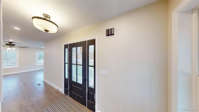 a view of a hardwood floor and windows